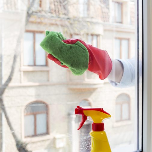 hand-with-rubber-glove-cleaning-the-window